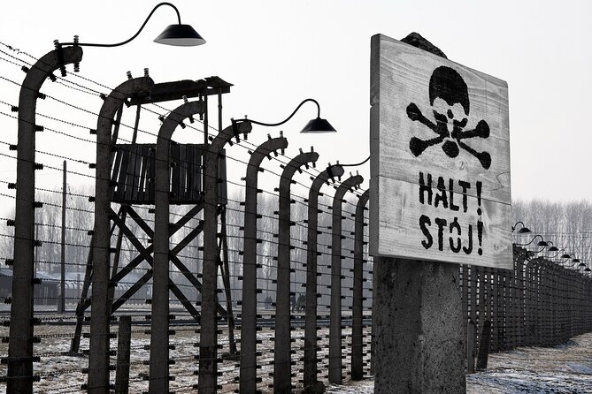 Auschwitz-Birkenau Memorial and Museum Guided Tour from Krakow - Entering Auschwitz I with a museum guide