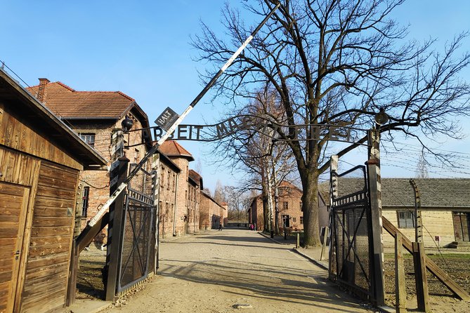 Krakow to Auschwitz Birkenau and Salt Mine 1 Day Tour - Entering Auschwitz I with a museum guide